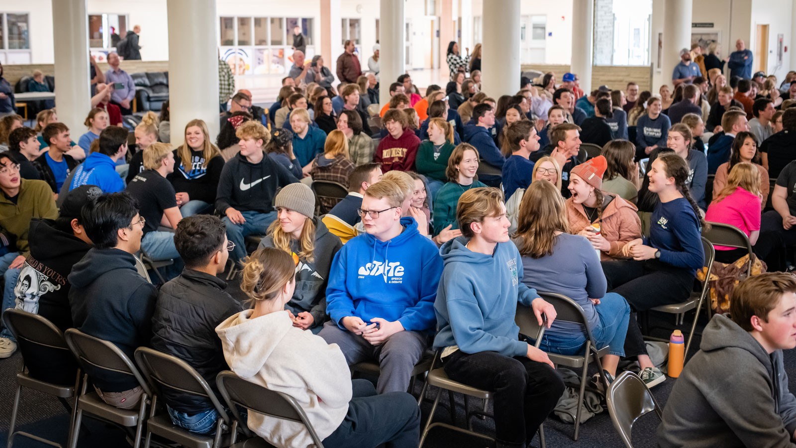 Students speaking with each other at an academic competition.