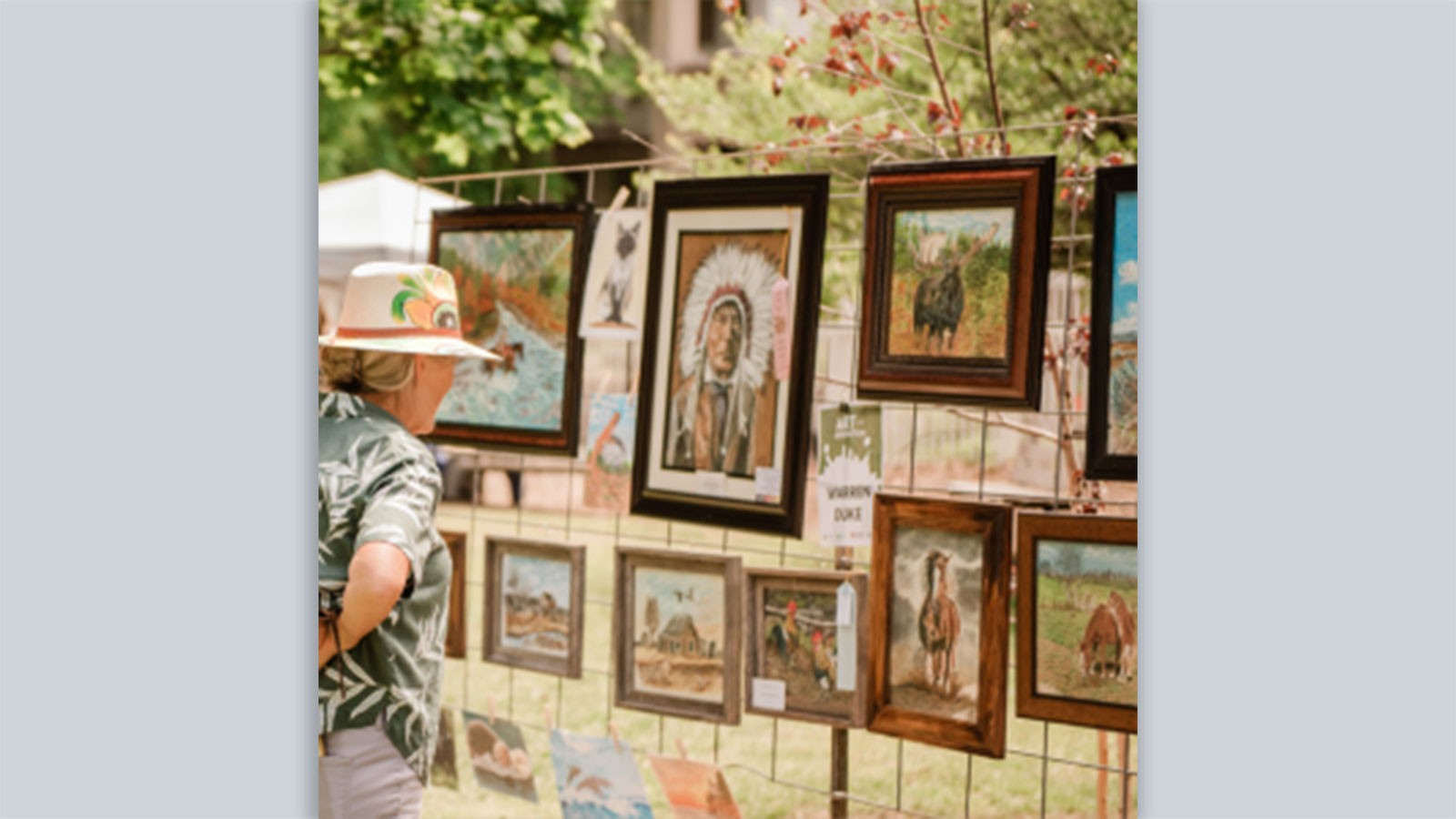 A person looking at art in an outdoor gallery.