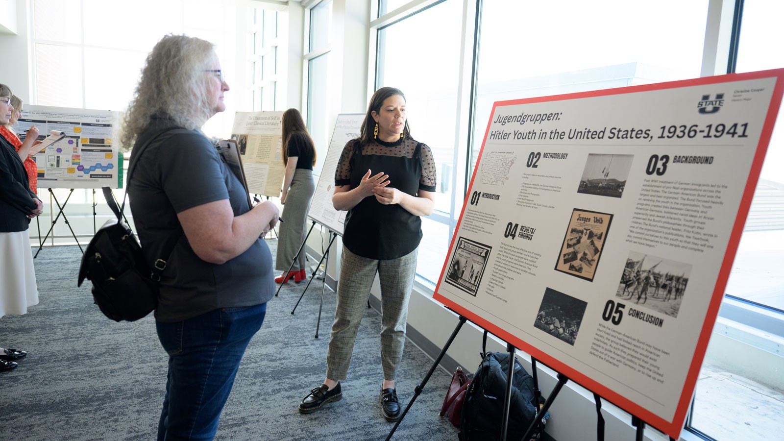 People discussing a research poster.