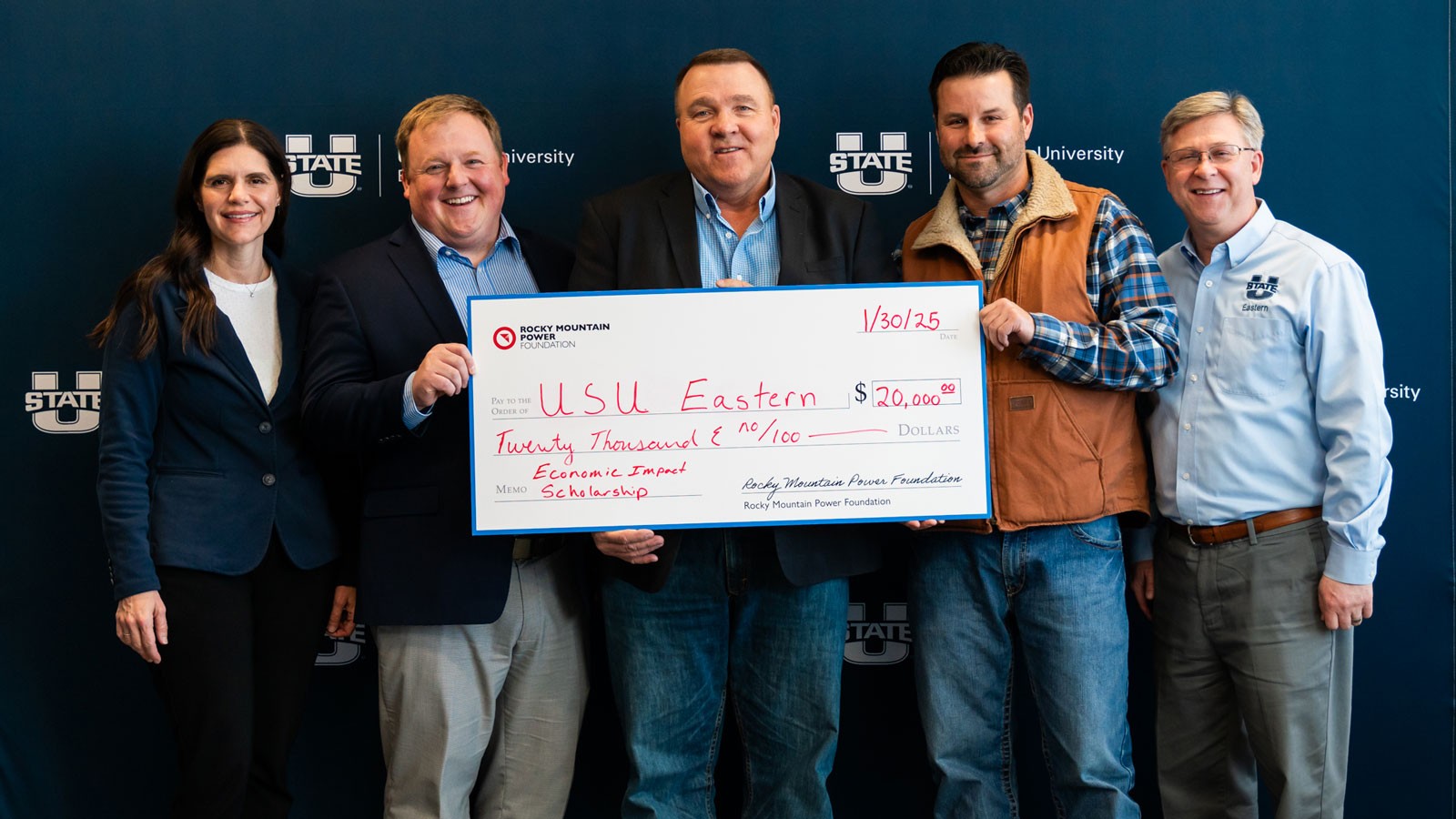 People standing with a giant check for $20,000 to USU Eastern from Rocky Mountain Power.