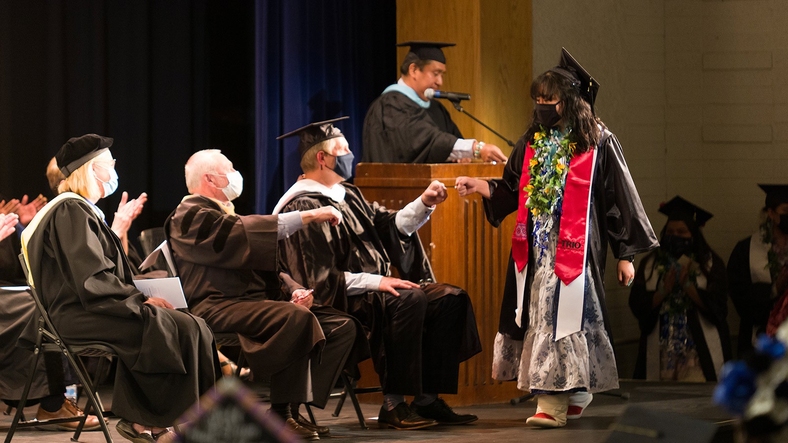 A USU Blanding graduate walks on stage after name is read during the 2021 Commencement ceremony.