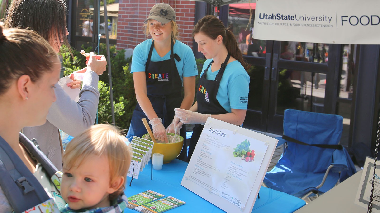 USU students in a booth at a Farmer's Market.