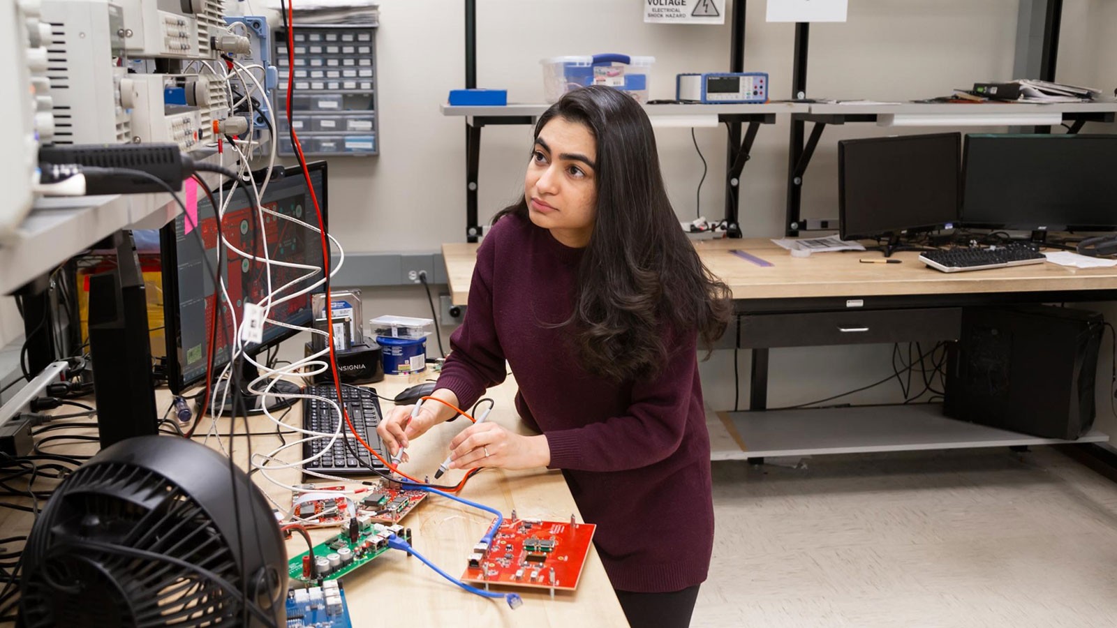 Marium Rasheed tests electronic equipment in a laboratory at Utah State University.