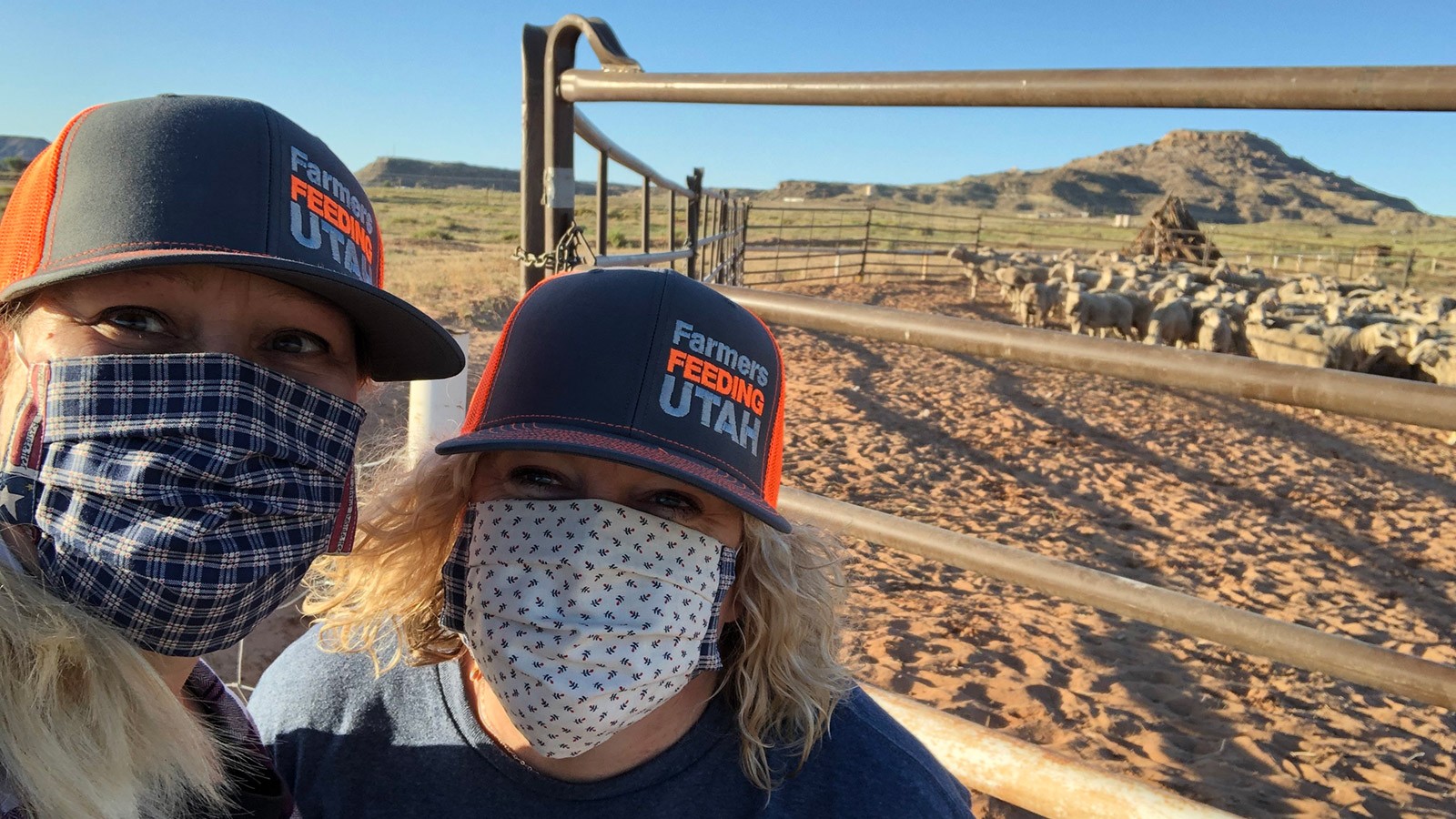 Two women in masks delivering food to Miracle project 1, Montezuma Creek.