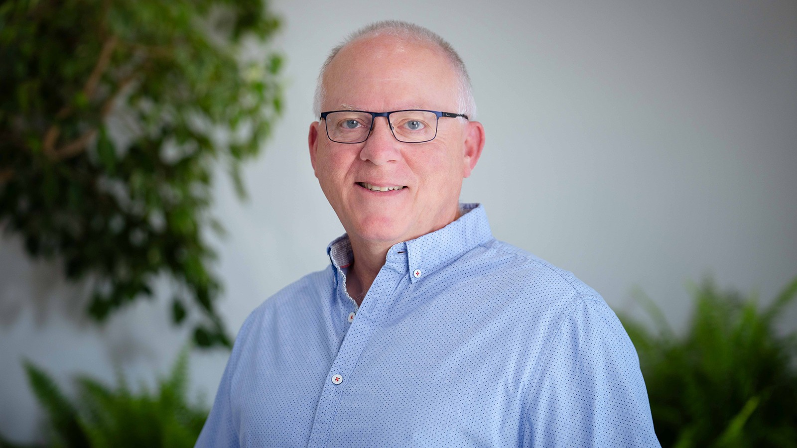 A man poses for a headshot.