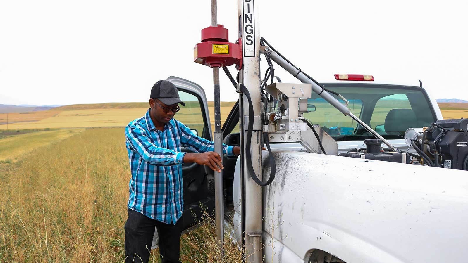 Idowu Atoloye looking over equipment while out in the field.