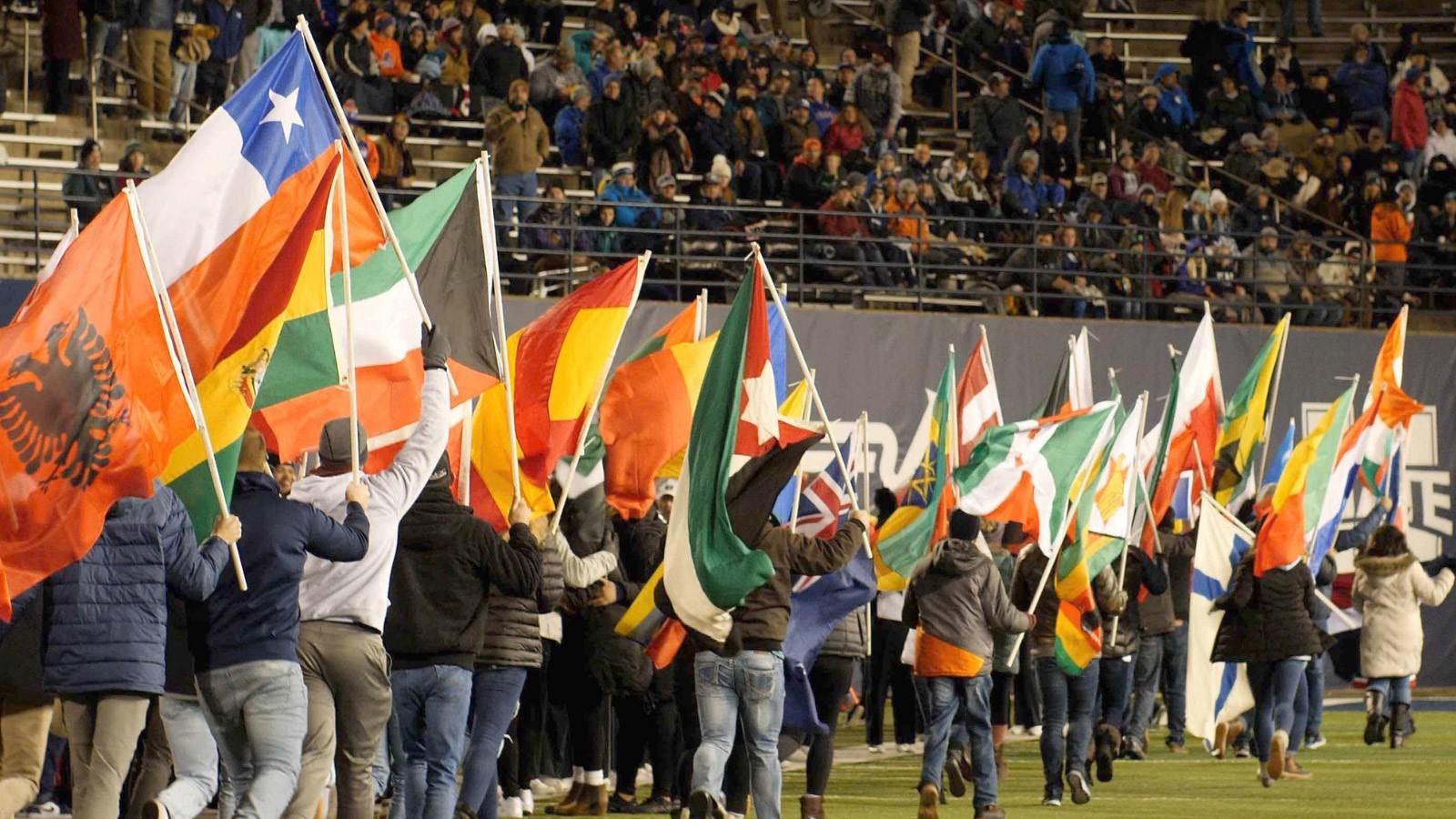 International flags fly at USU's Maverik Stadium.