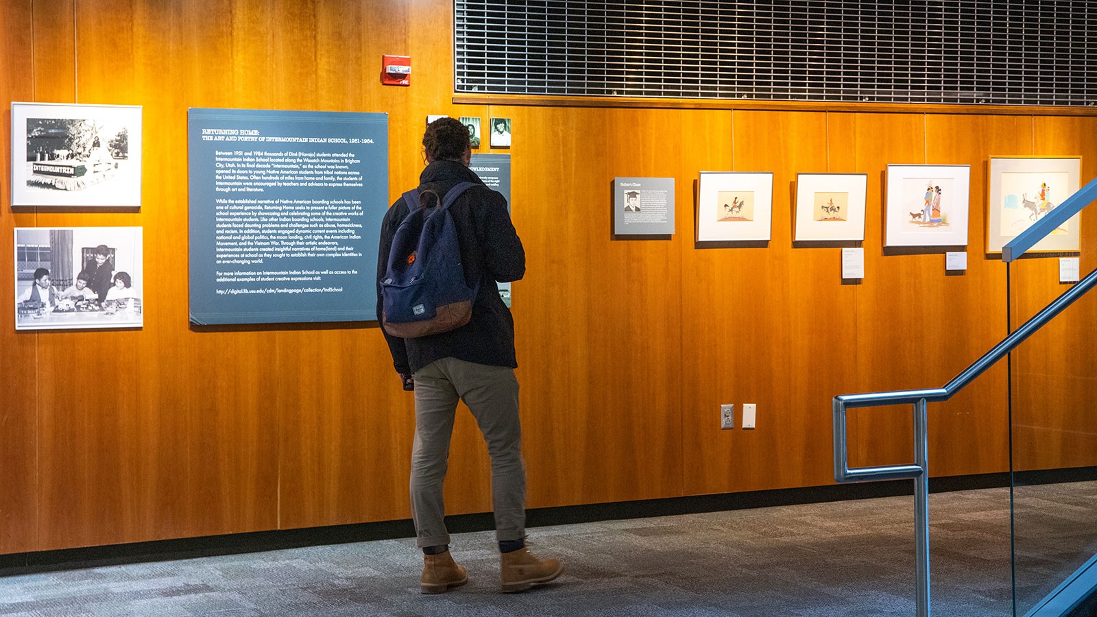 A person examines an art exhibit.