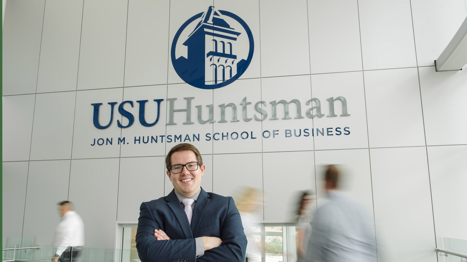 student standing in Huntsman Hall on the USU campus.