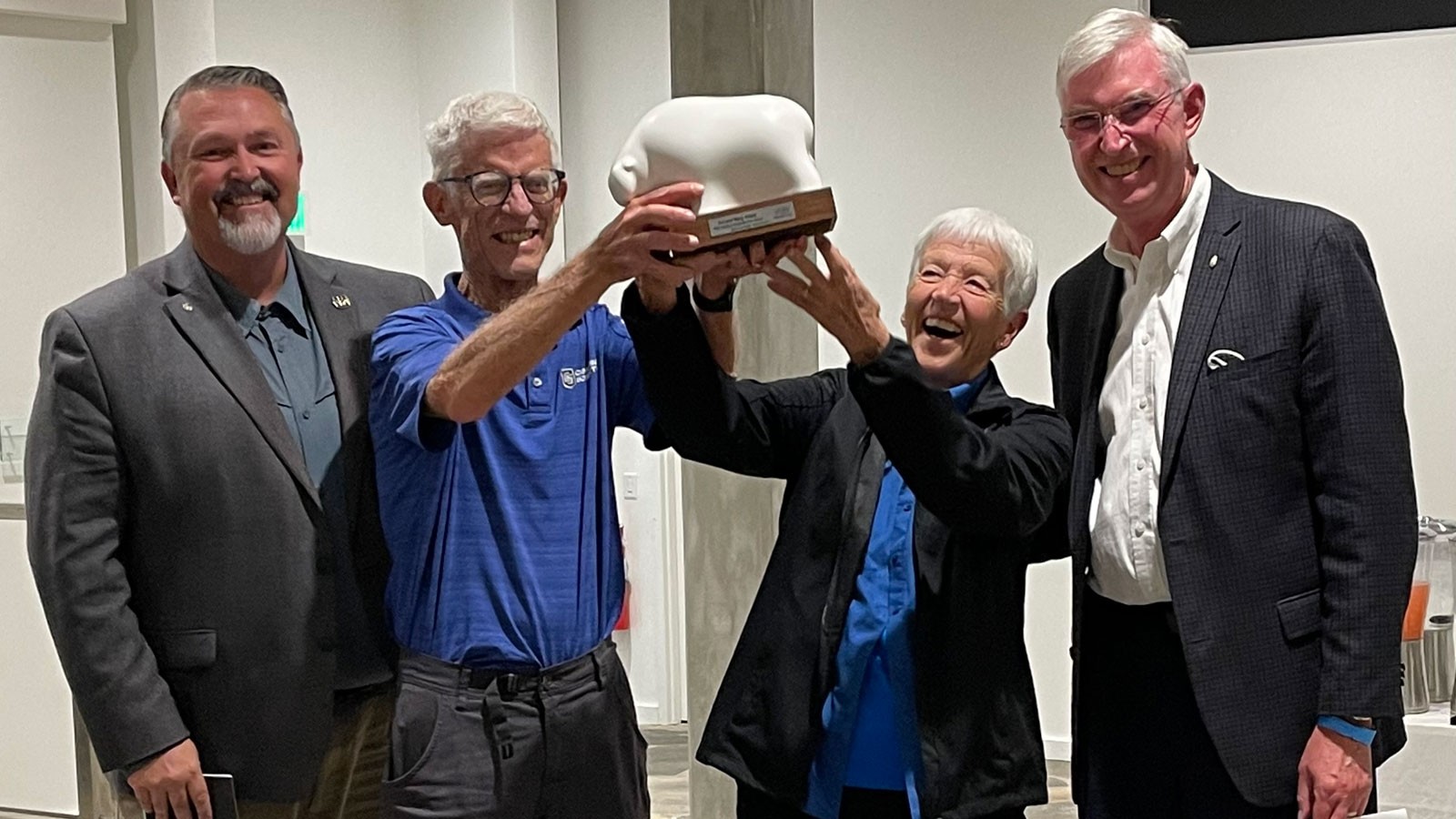 Mary and Art Heers holding a sculpture.
