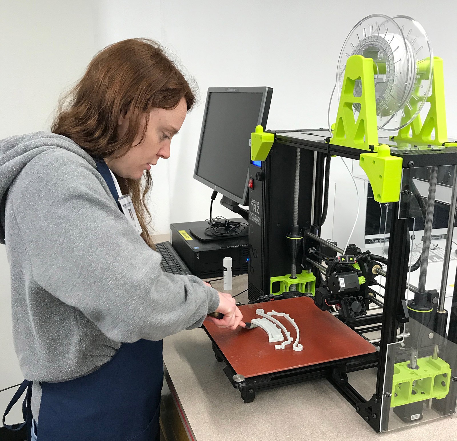 USU Eastern LLC Student employee, Holly Fellmeth, making a face shield.