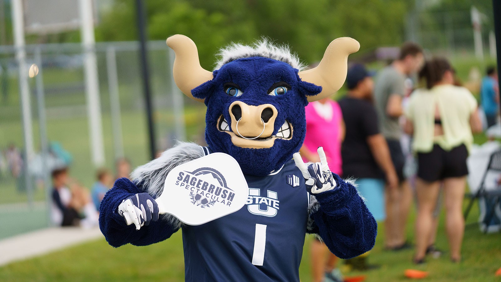 Utah State mascot Big Blue holding a pickleball paddle.