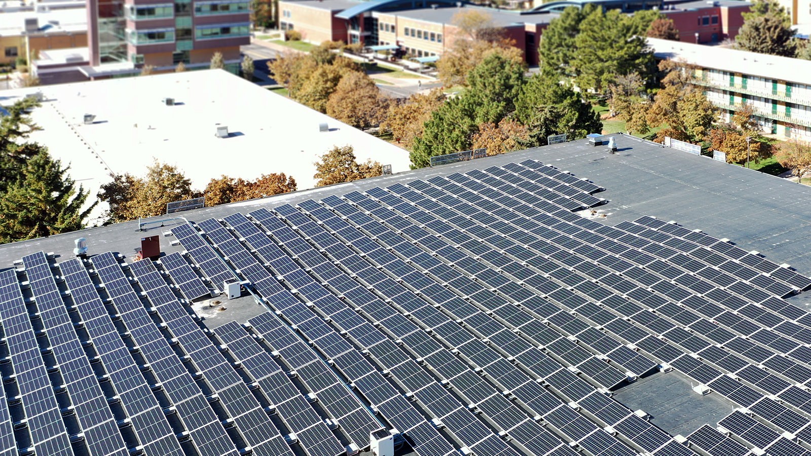 Solar panels line a parking terrace rooftop.
