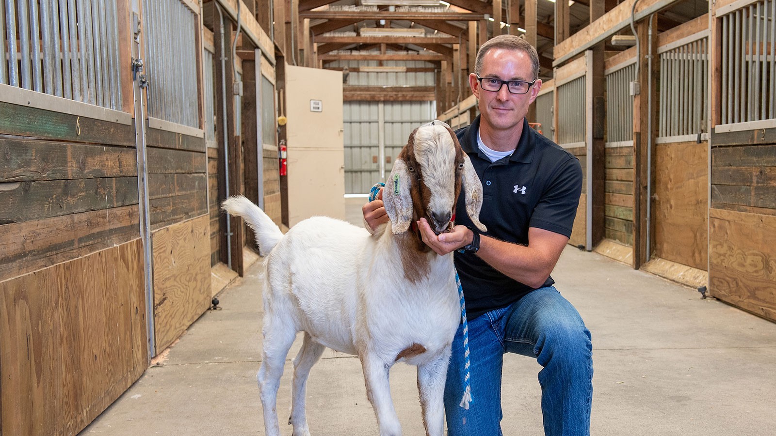 Jon Oatley, a reproductive biologist with Washington State University holding a goat.