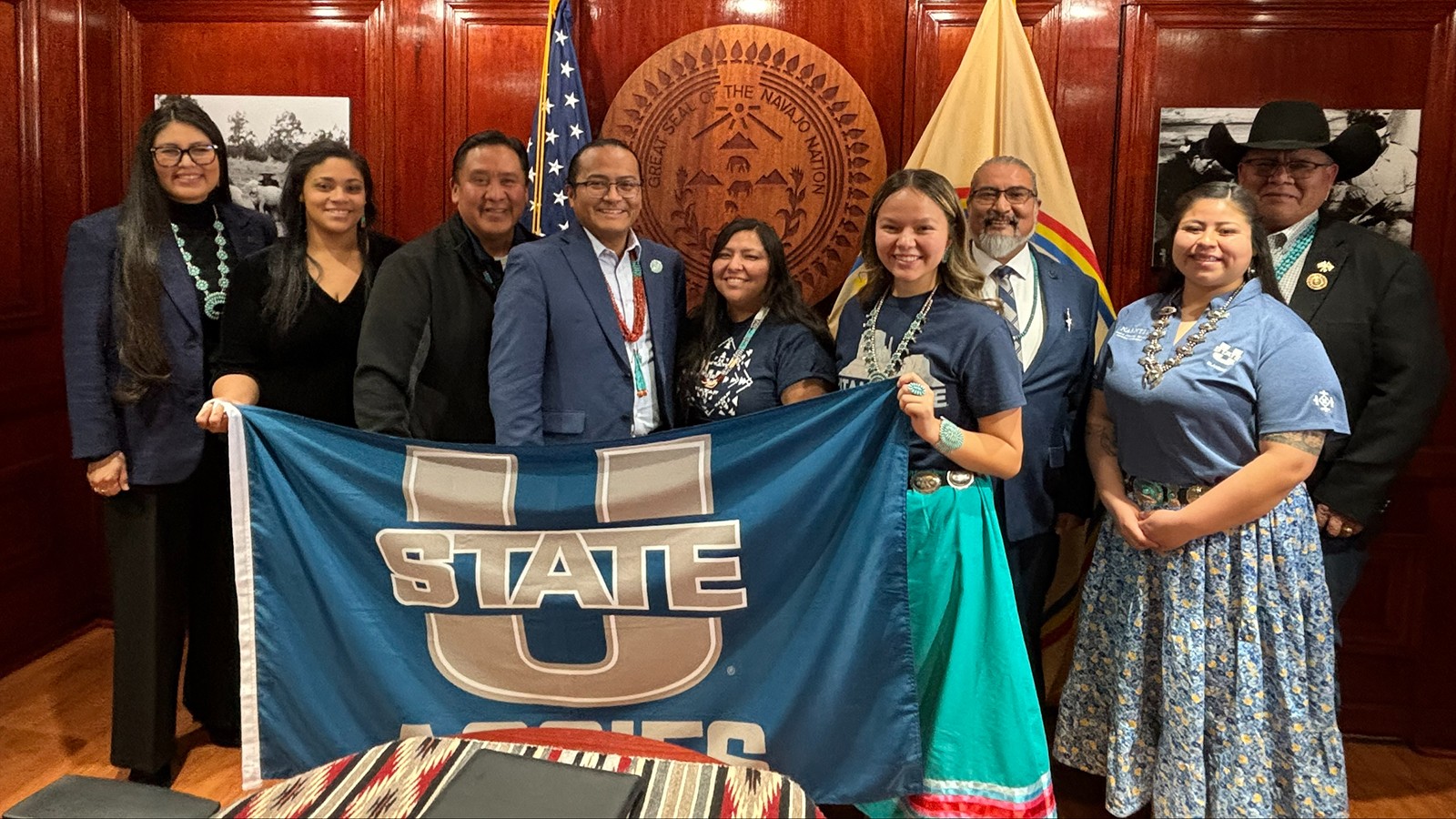 A group of people pose for a photo in an office.