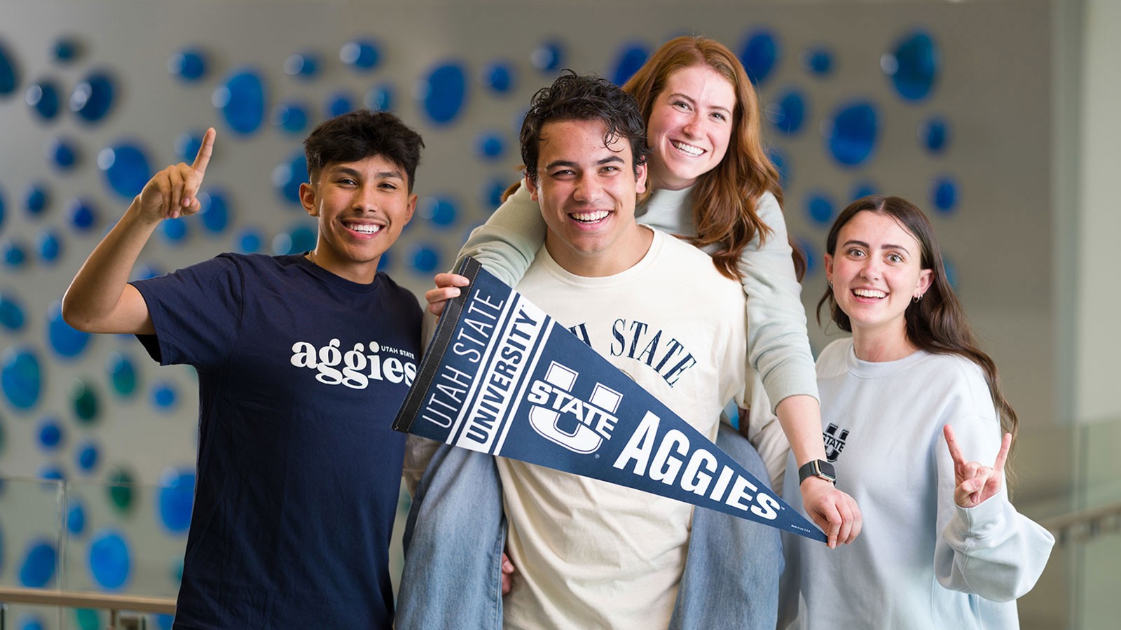 Students posing with Aggie paraphernalia.