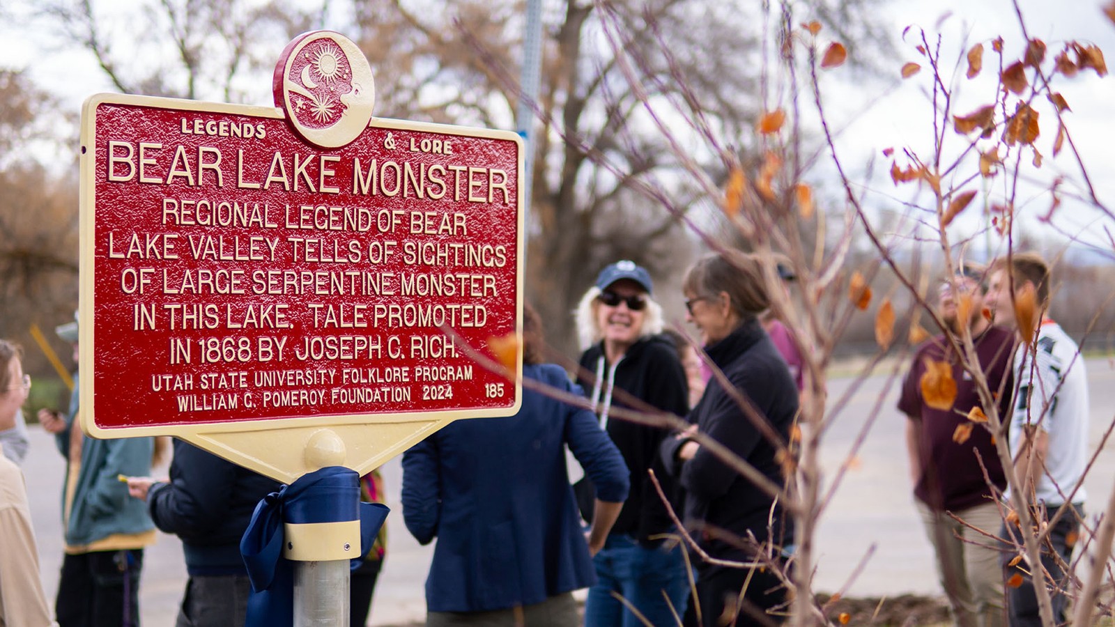 A close up of a marker near a lake