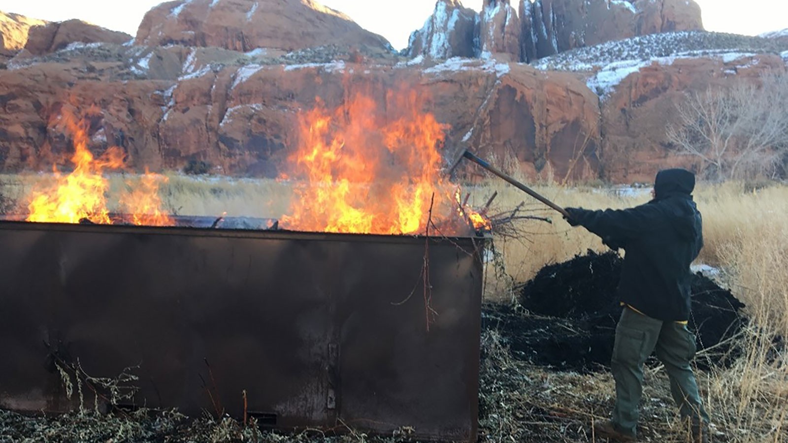 A firefighter from the Lone Peak Engine Crew tends a big box kiln.