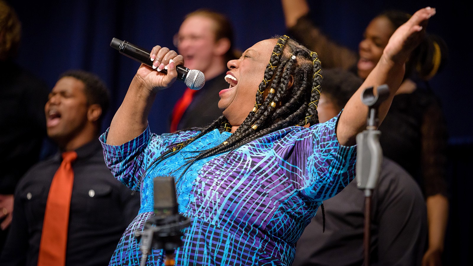 A woman sings on stage.