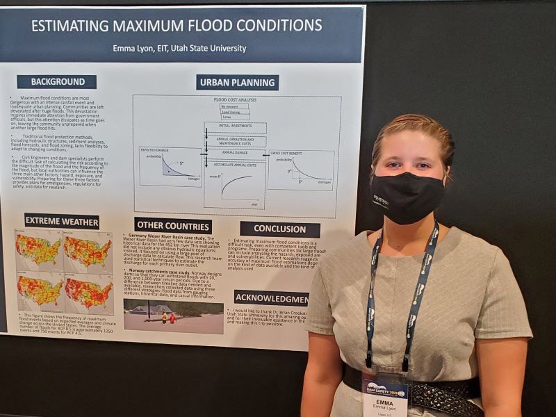 Emma Lyon stands with her poster at the Association of State Dam Safety Officials in Nashville.