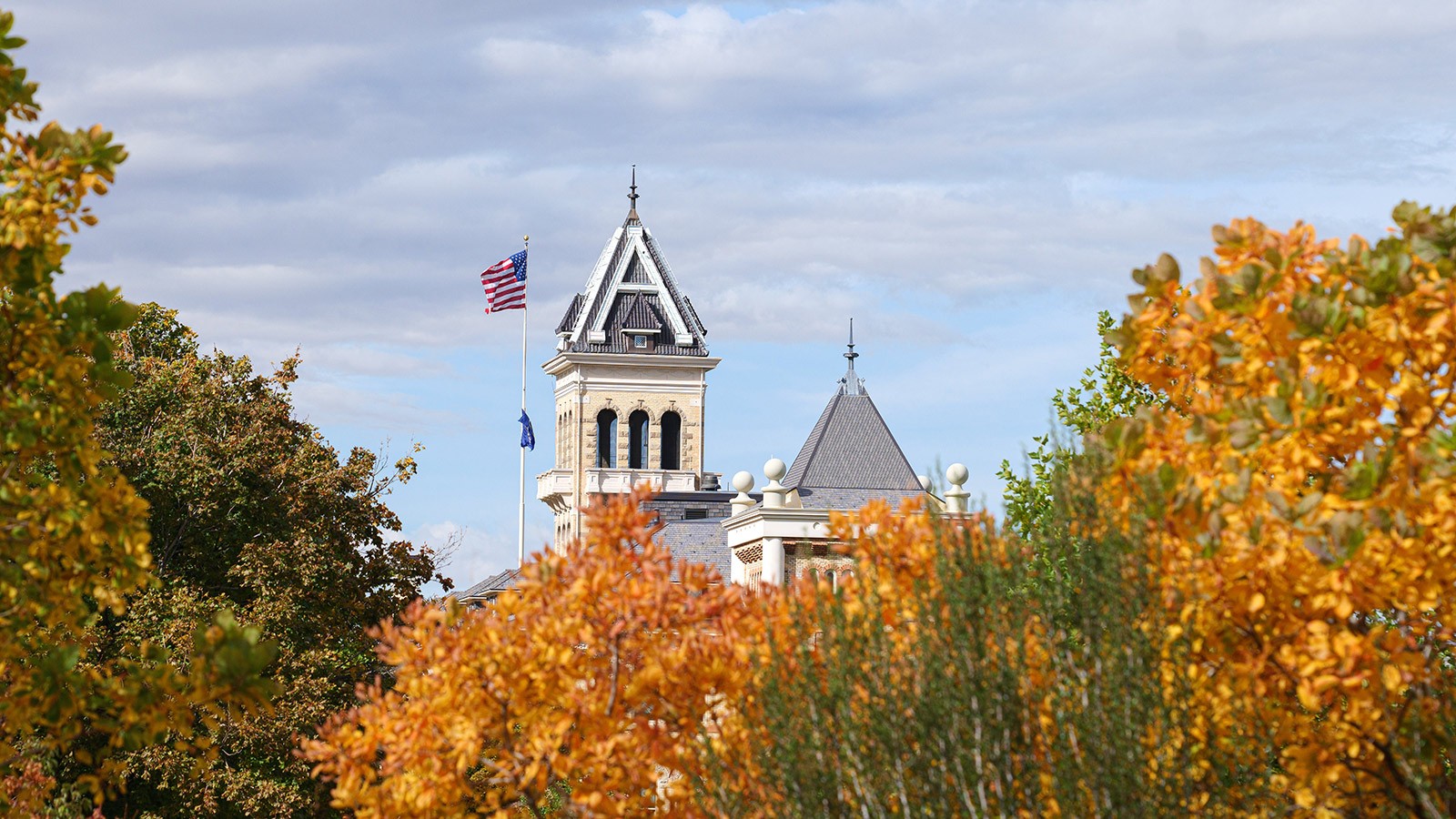 Old main with fall leaves in the background.