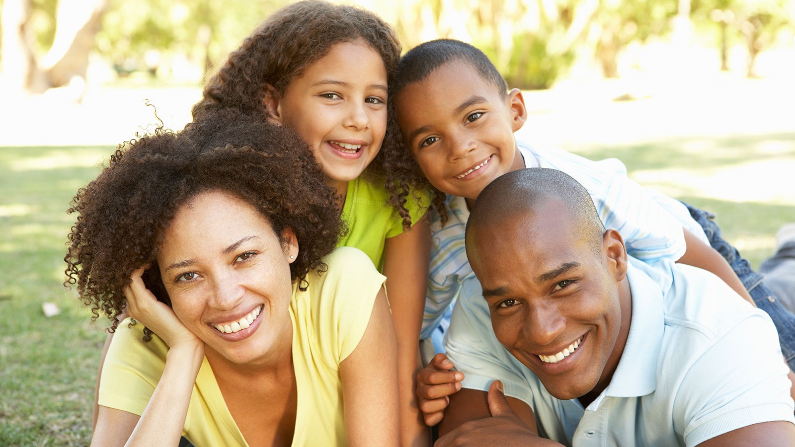 mother and father huddle in with two children.