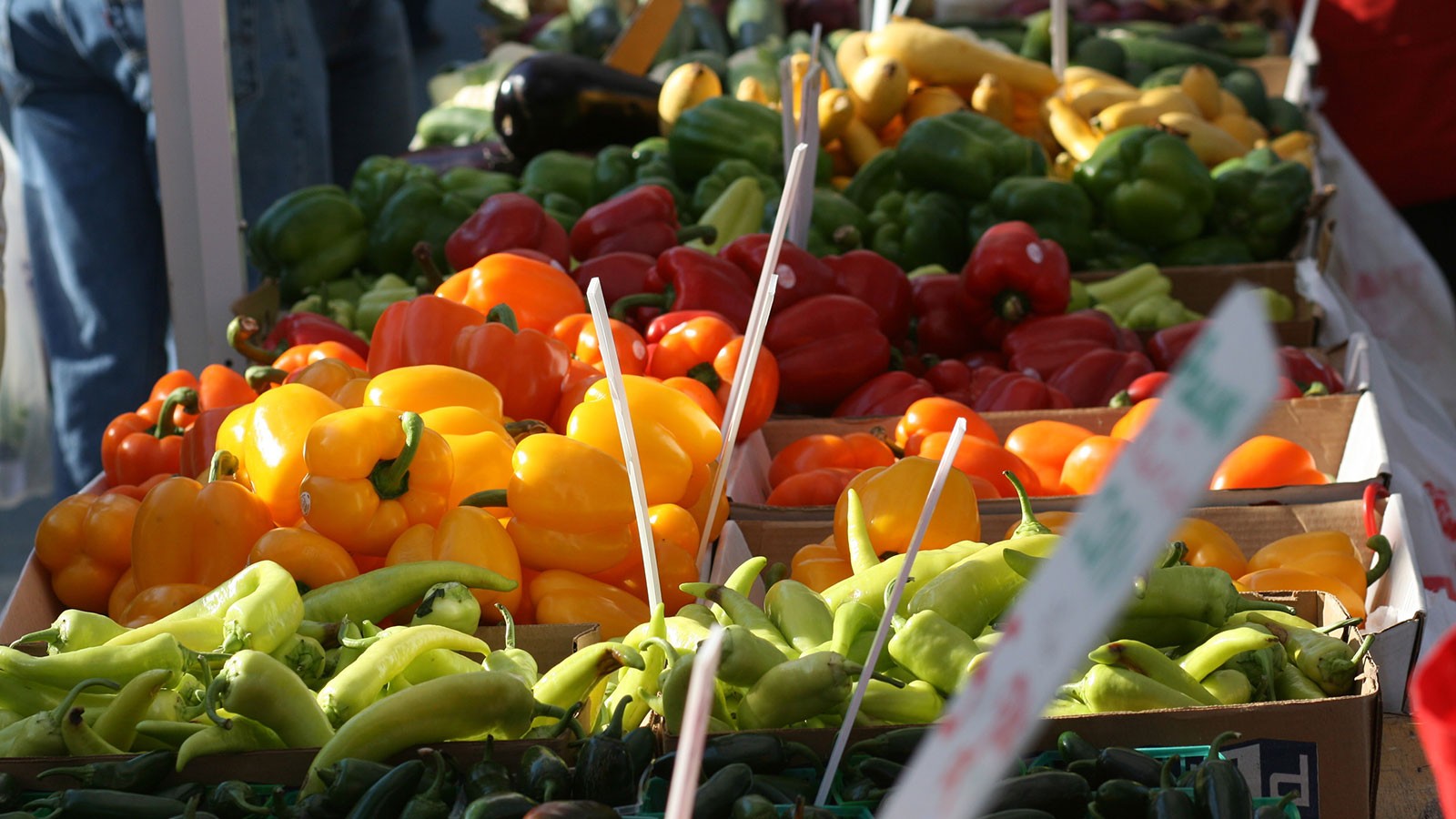 colorful bell peppers on a farmer's market stand.