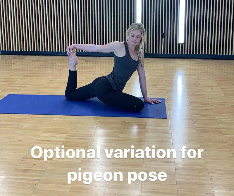 woman doing a variation of a pigeon yoga pose.