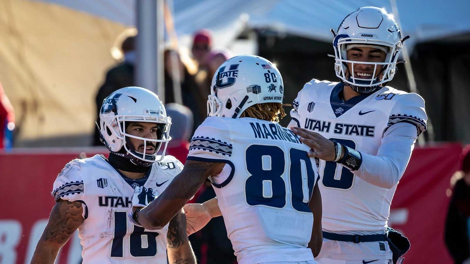 USU Football players give each other a congratulatory pat on the back.