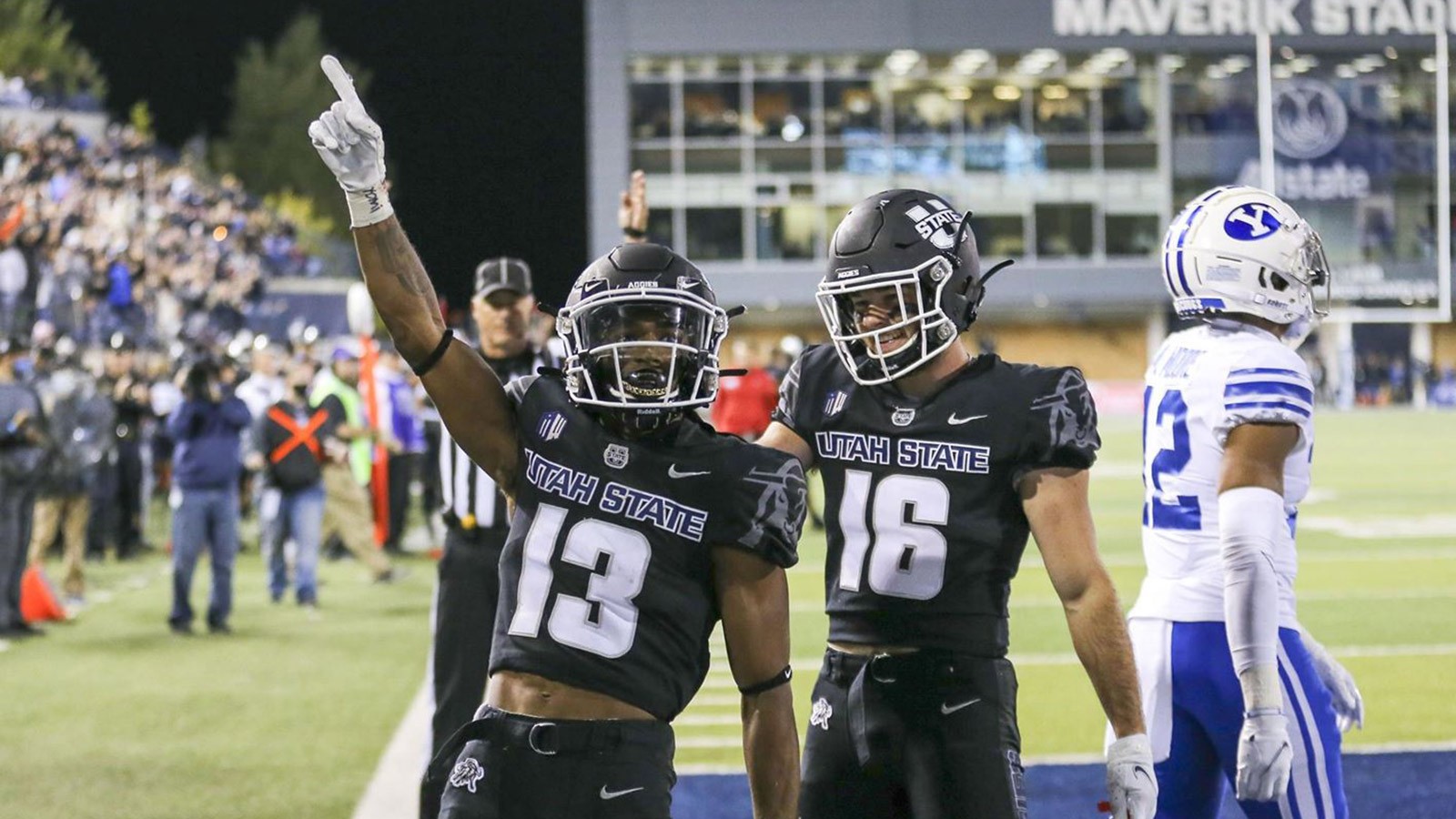 Two USU football team members on the field.