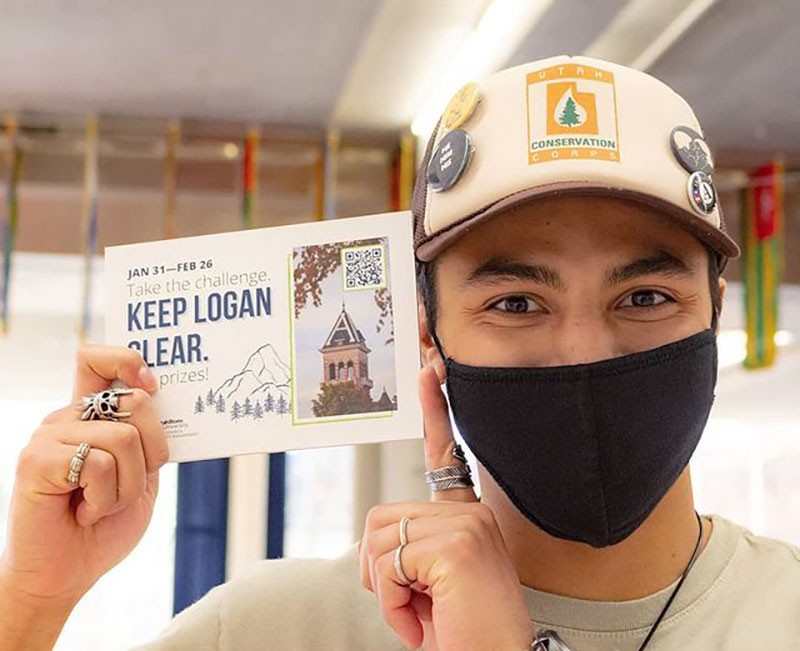 USU student holding a sign saying