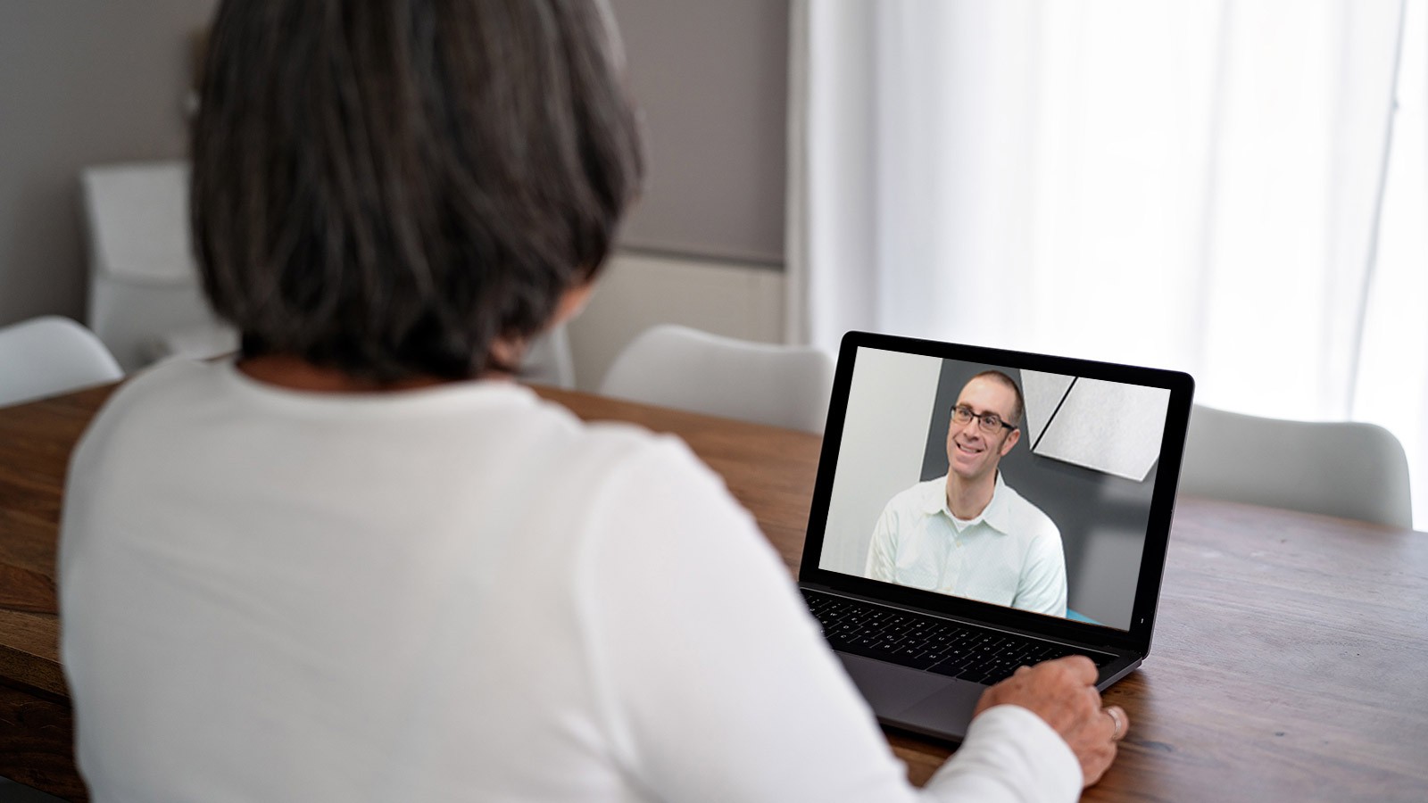 Mike Twohig, Psychology professor, counsels a client via Telehealth.