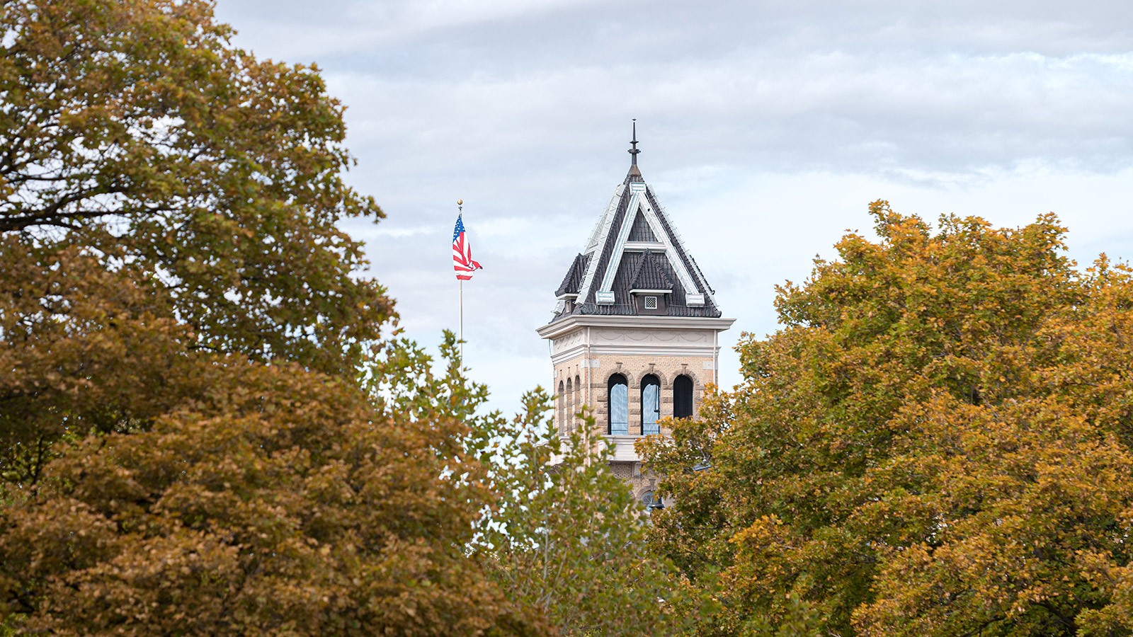 Old main surrounded by trees.