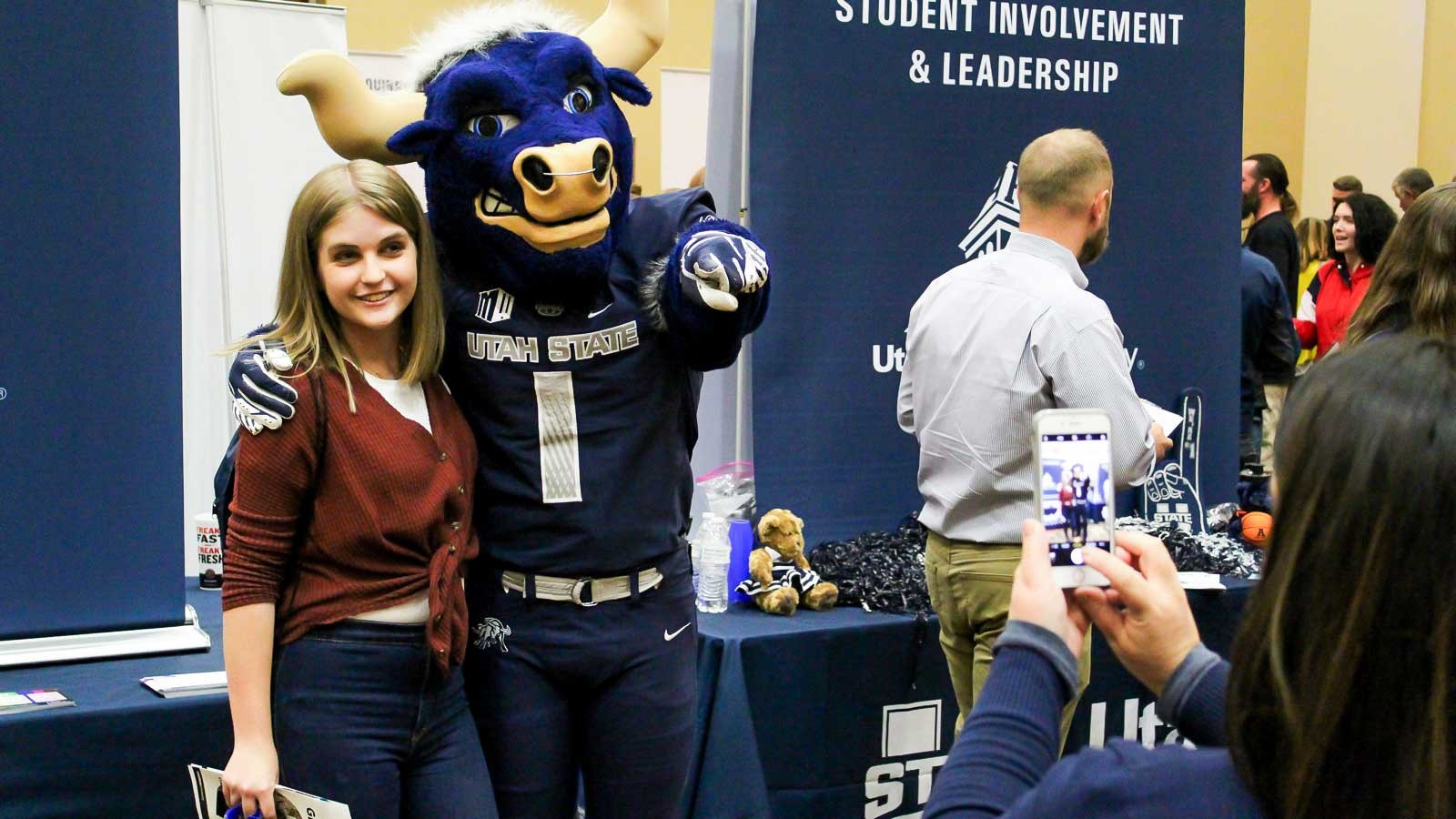 Ali Thomas, Senior at Davis High School poses with Big Blue.