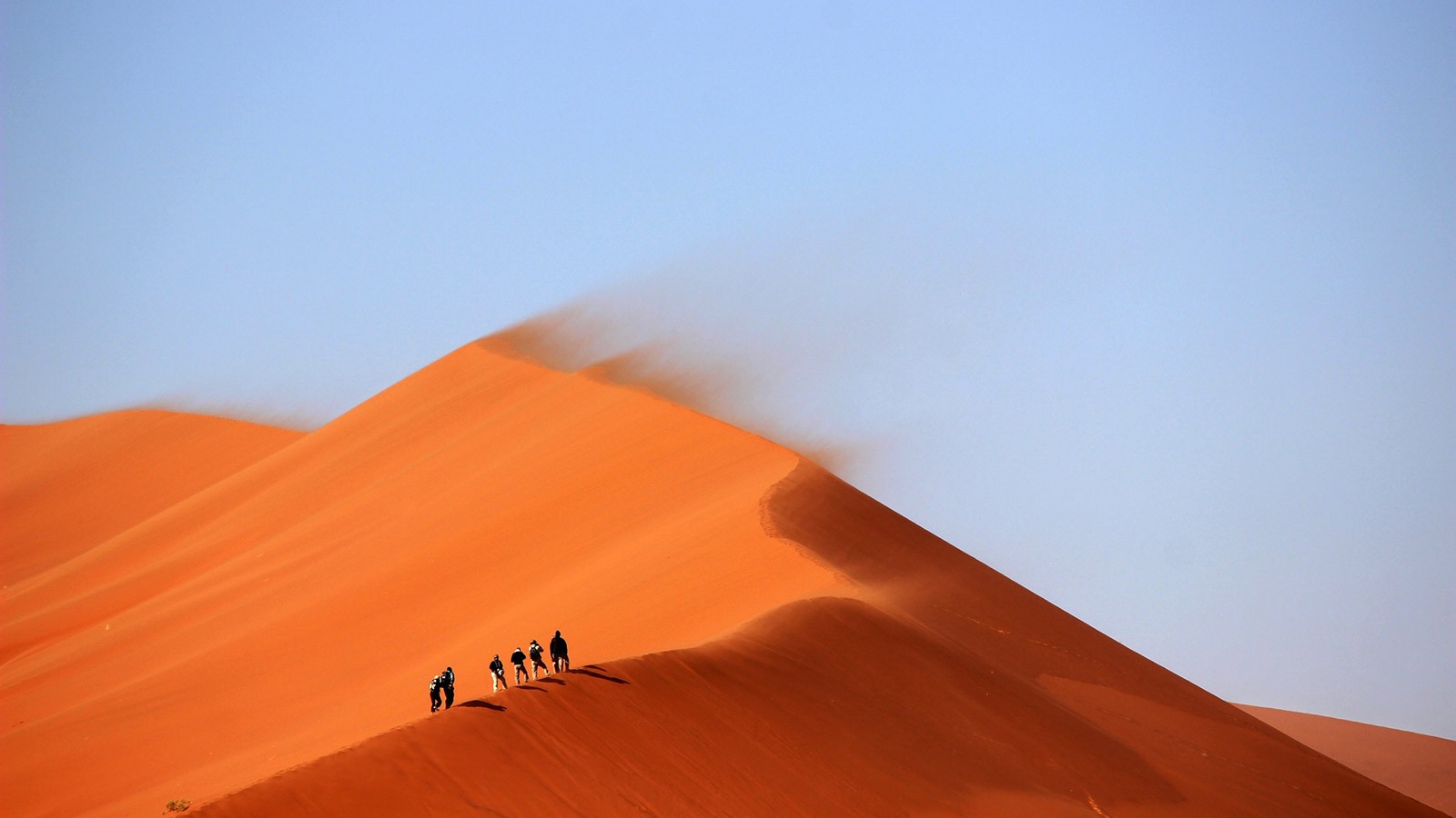 Hikers traversing a landscape.