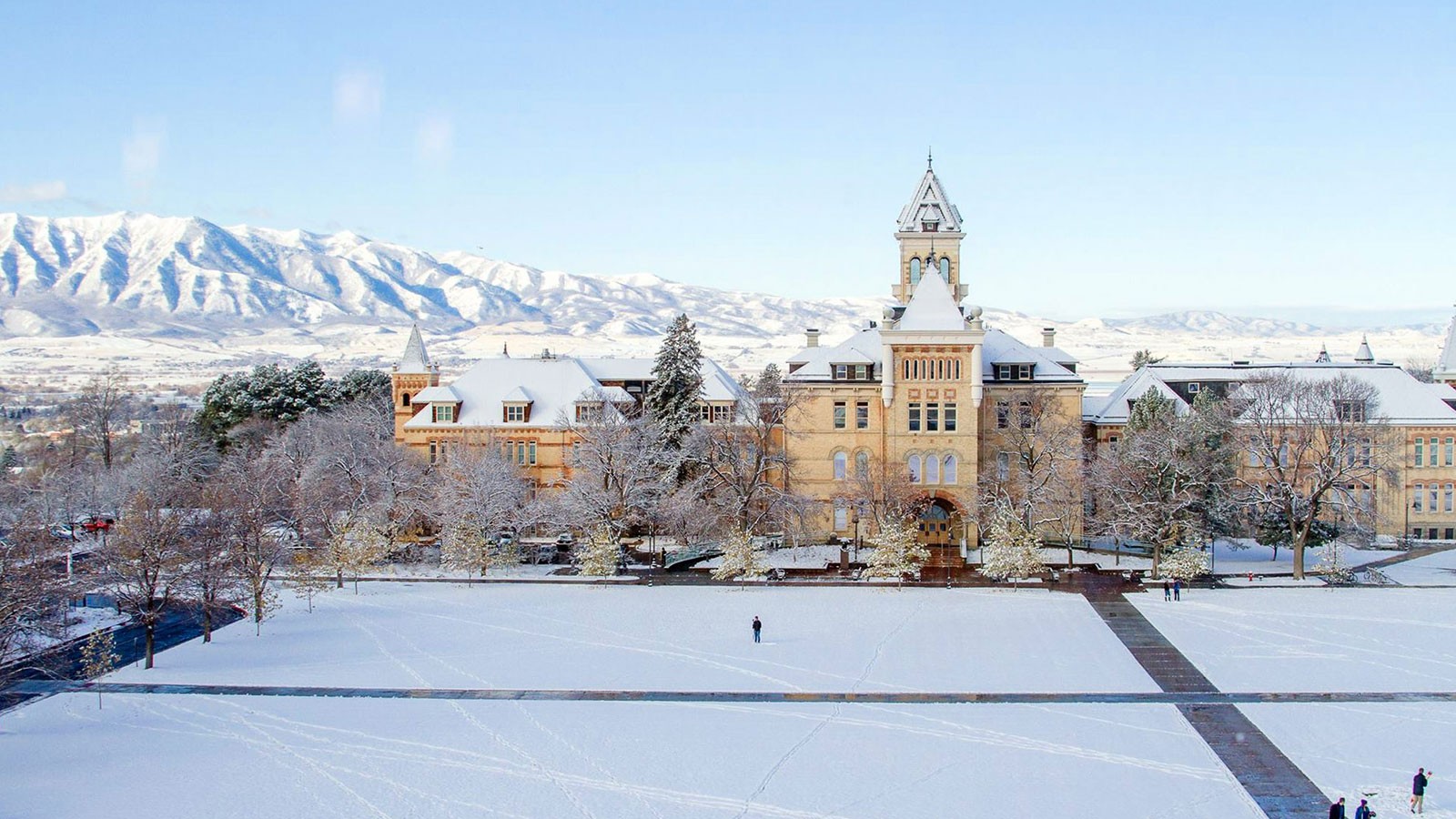 The USU Quad covered in snow with Old Main in the background.