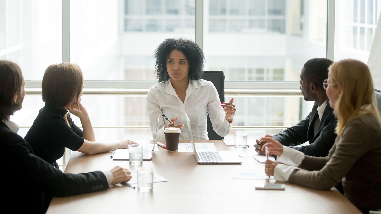 woman leading a meeting in a conference room.