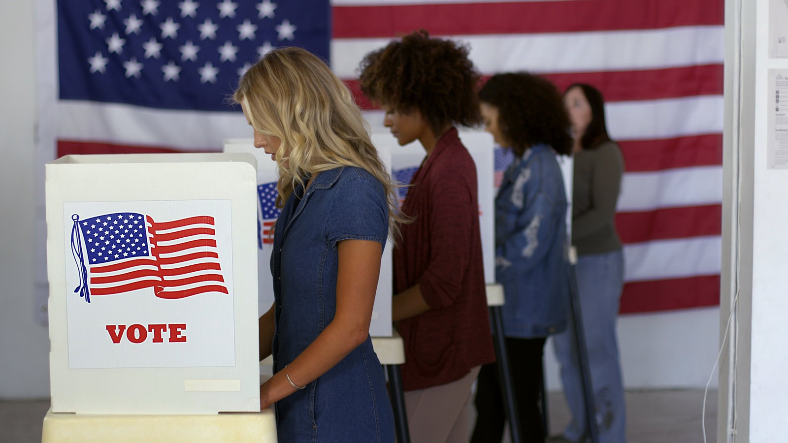 Women at a voting booth.