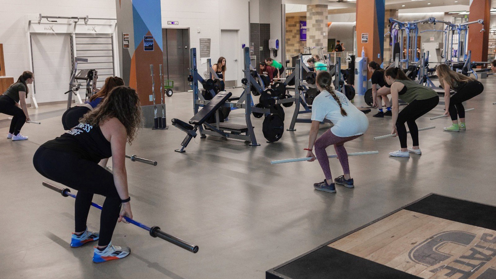 Women lifting weights in a class.